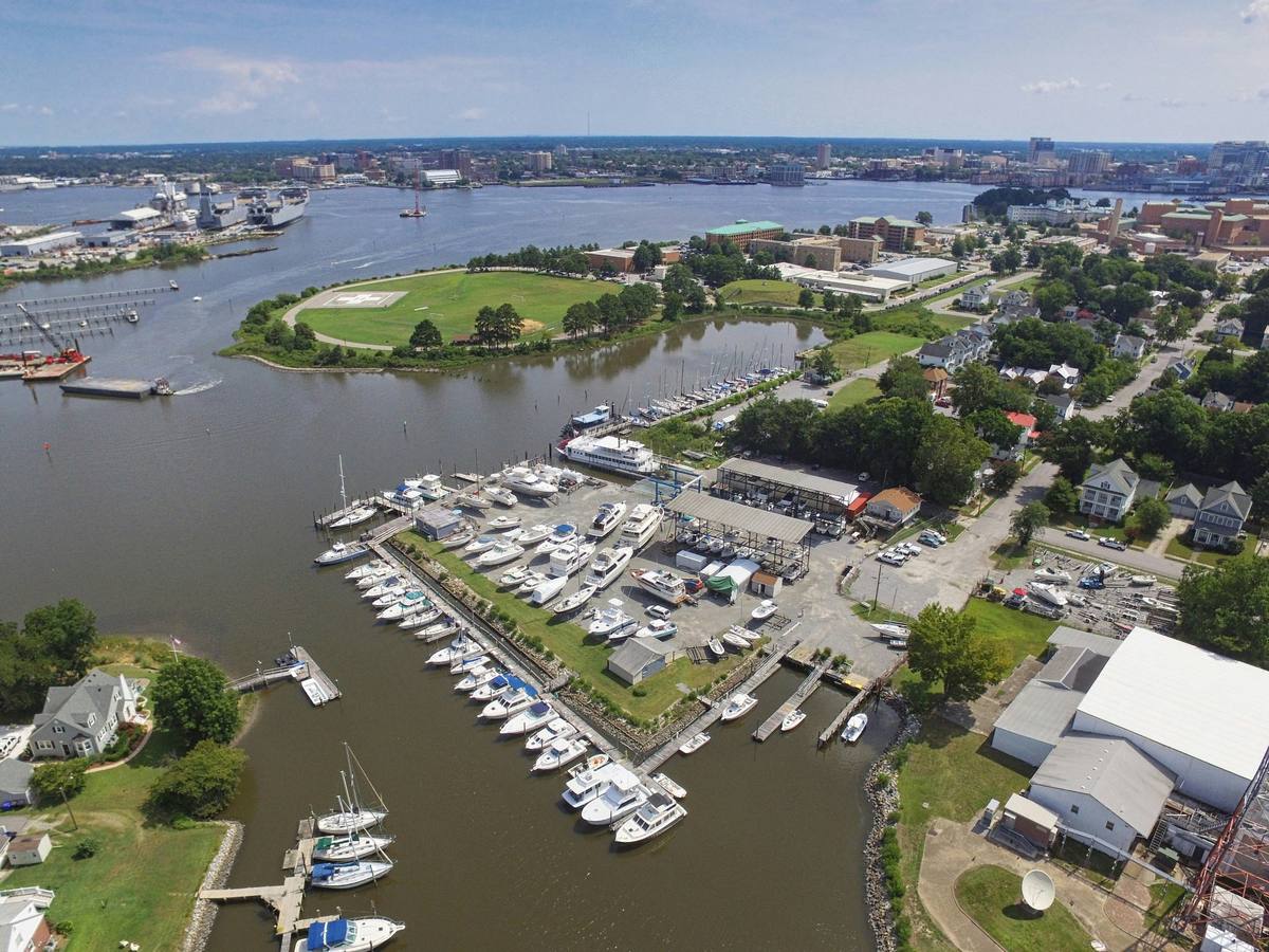 Aerial view of a Portsmouth marina, private piers and rip rap shoreline on the Elizabeth River, with downtown Norfolk across the water